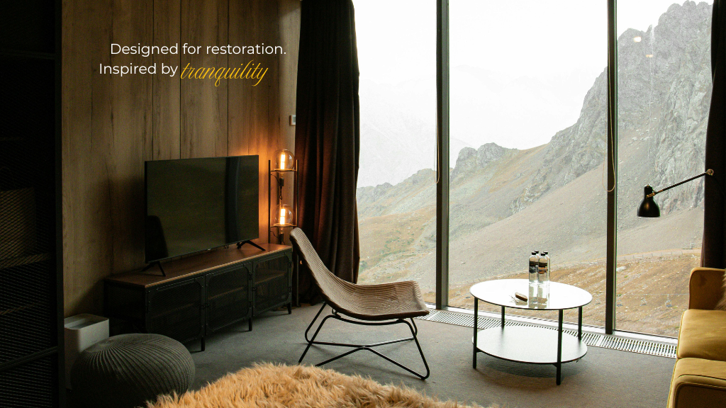 Tailored home retreat with artisan furnishings, a floor-to-ceiling window, and an inviting mountain backdrop.